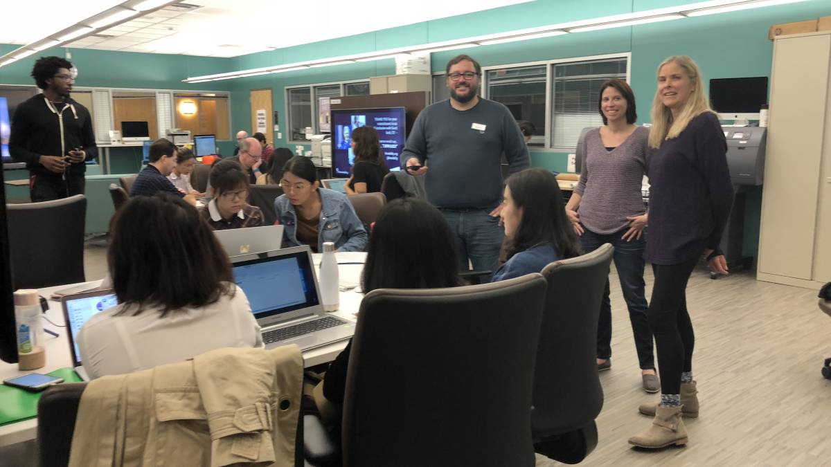 Student volunteer teams working in a computer lab.